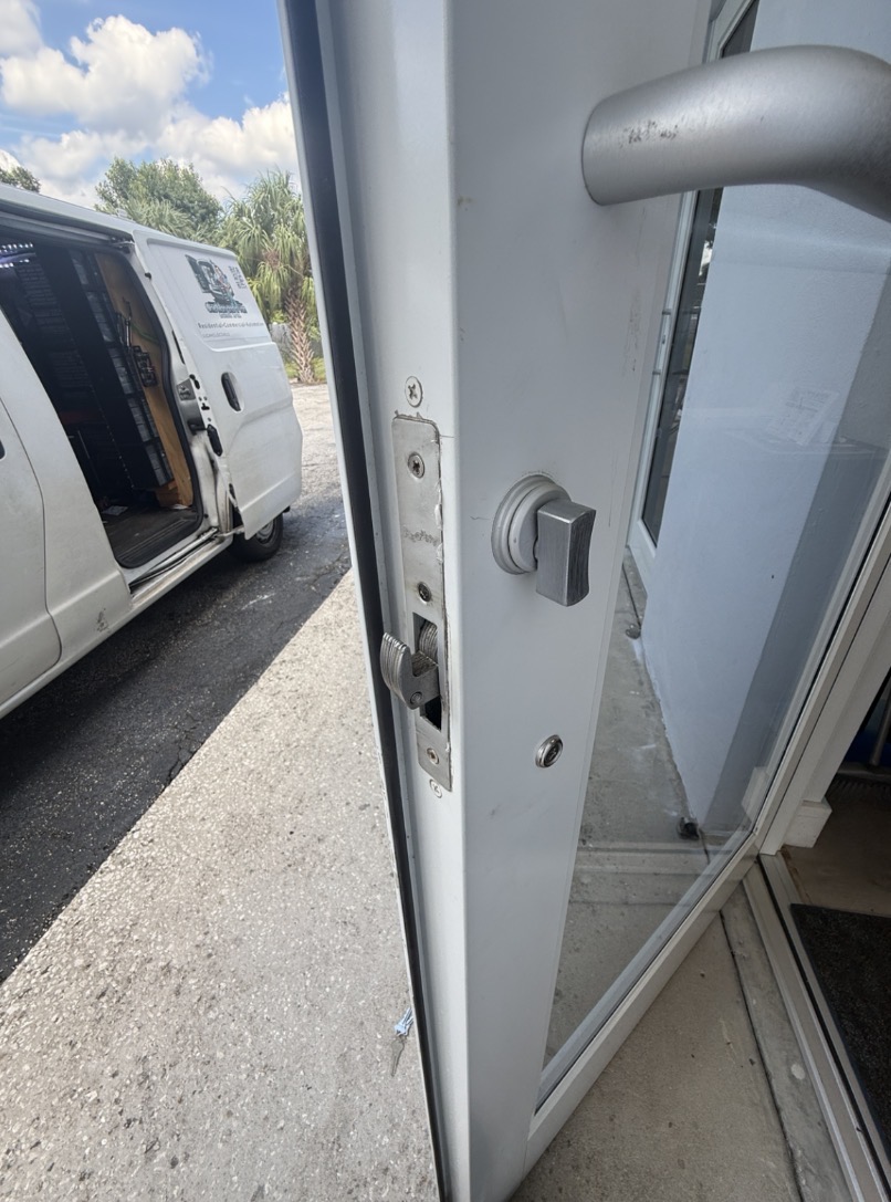 Commercial lock replacement service with One Man and a Van Locksmith van on site in Tampa